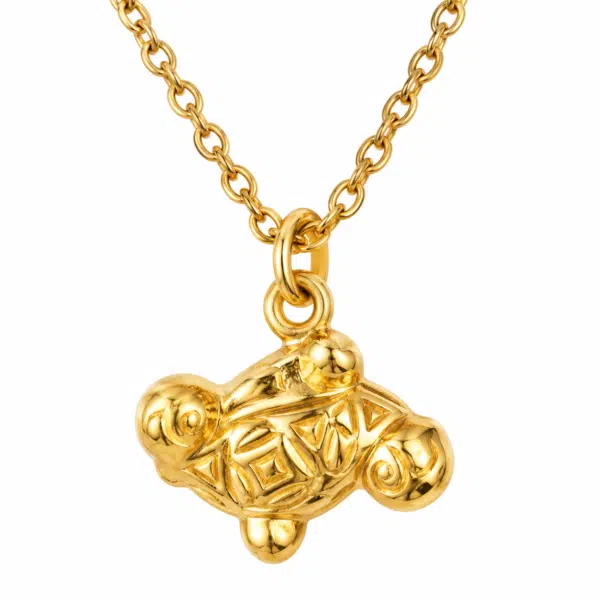 Macro view of the ornate golden turtle motif pendant