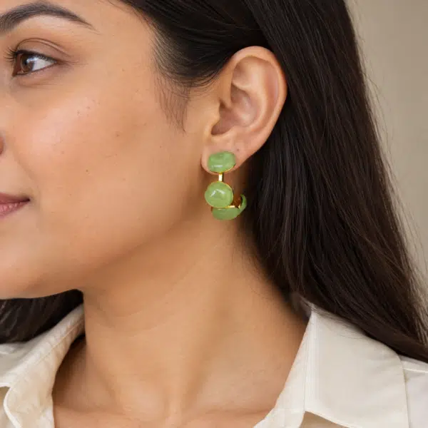 Model wearing green resin hoop earrings showing scale and fit