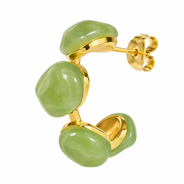 Detailed side profile of green resin hoop earring on white background