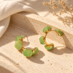 Front view of green resin hoop earrings on white background